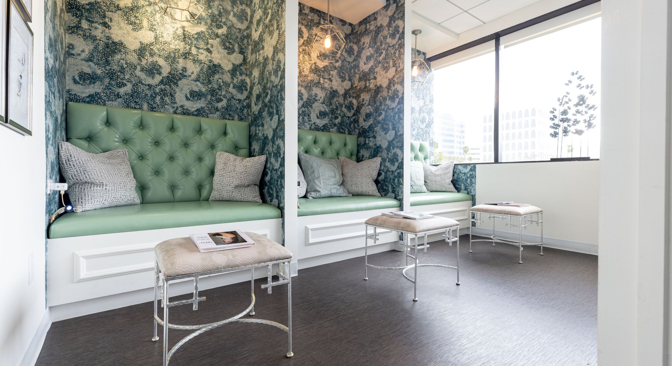 Modern seating area with green upholstered benches.