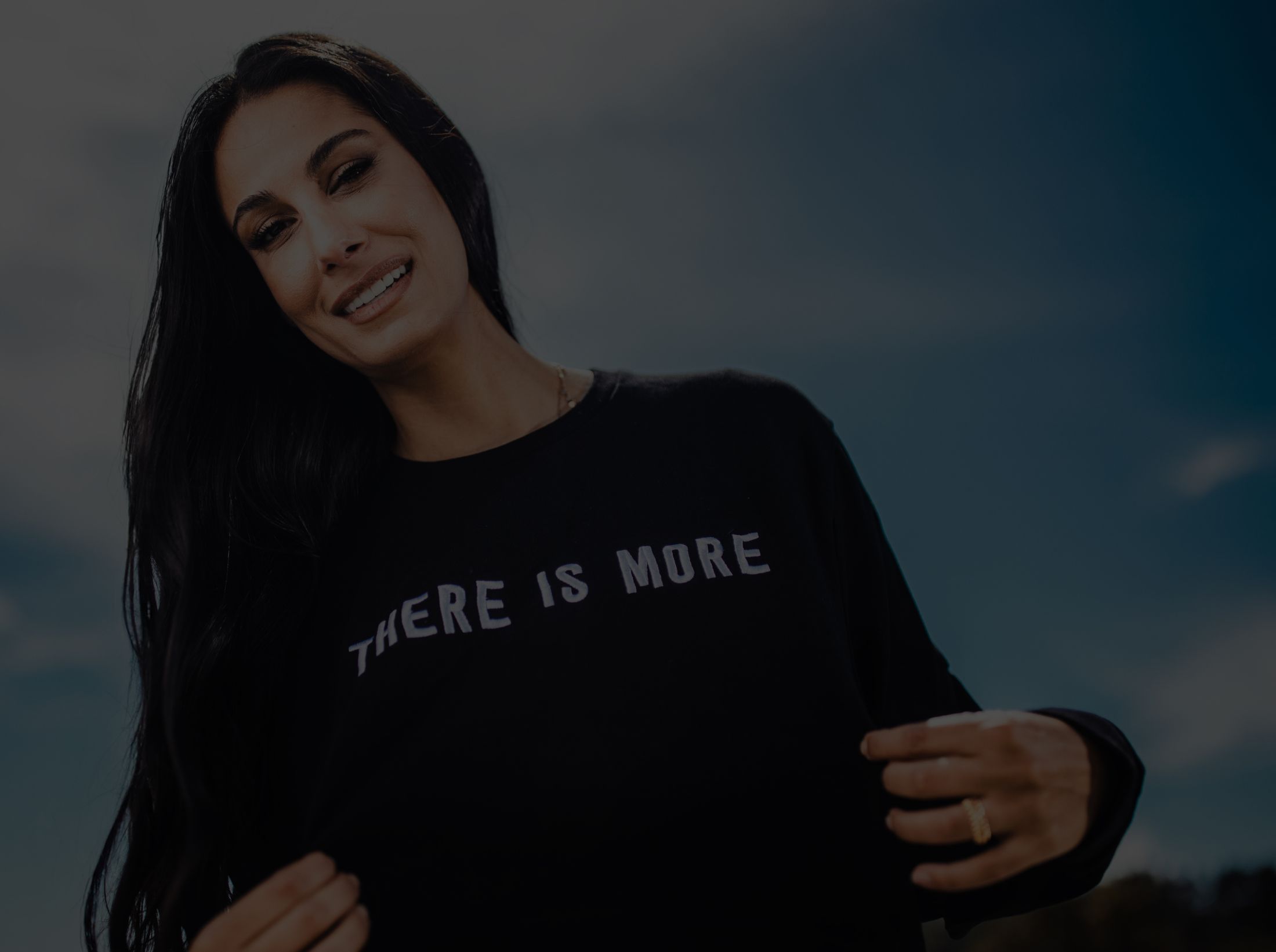 Woman wearing shirt that says "There is more."
