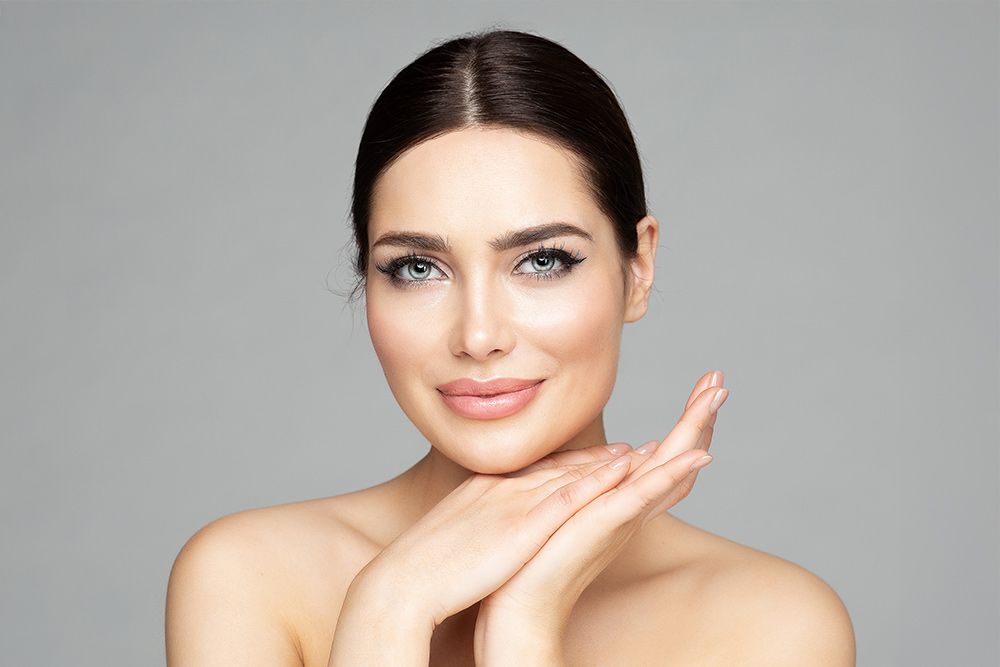 Smiling woman with beautiful skin and makeup.