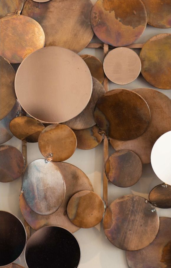 Decorative metal wall art with circular shapes.