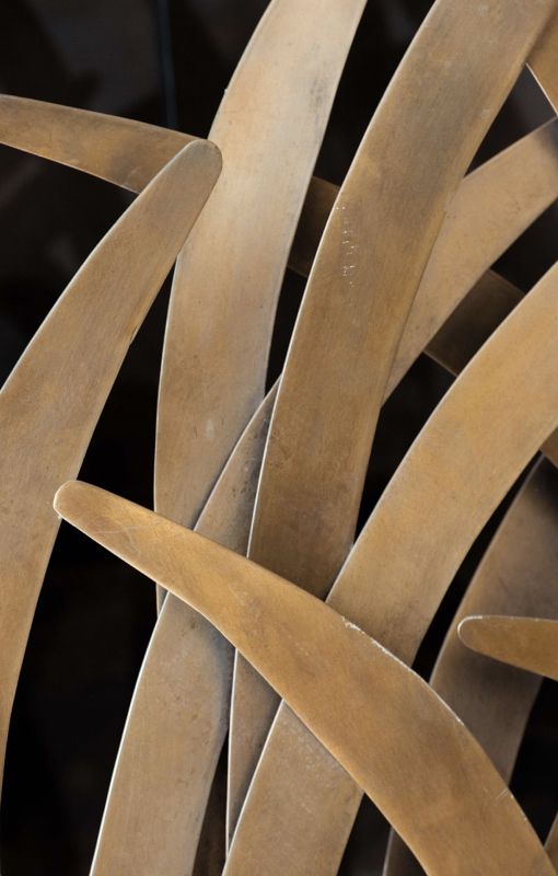 Abstract metallic sculpture with curved shapes.