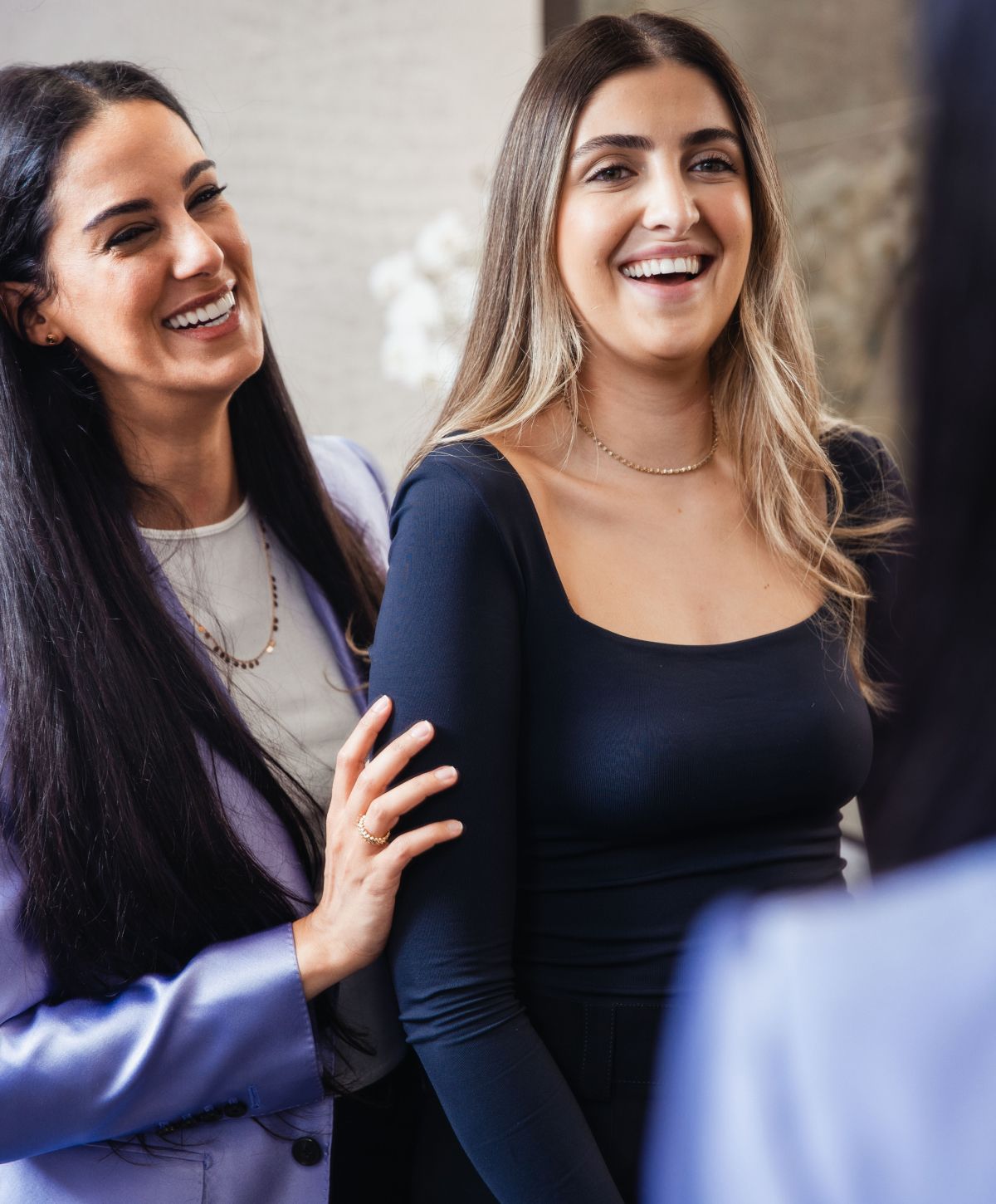 Two women smiling and enjoying each other's company.