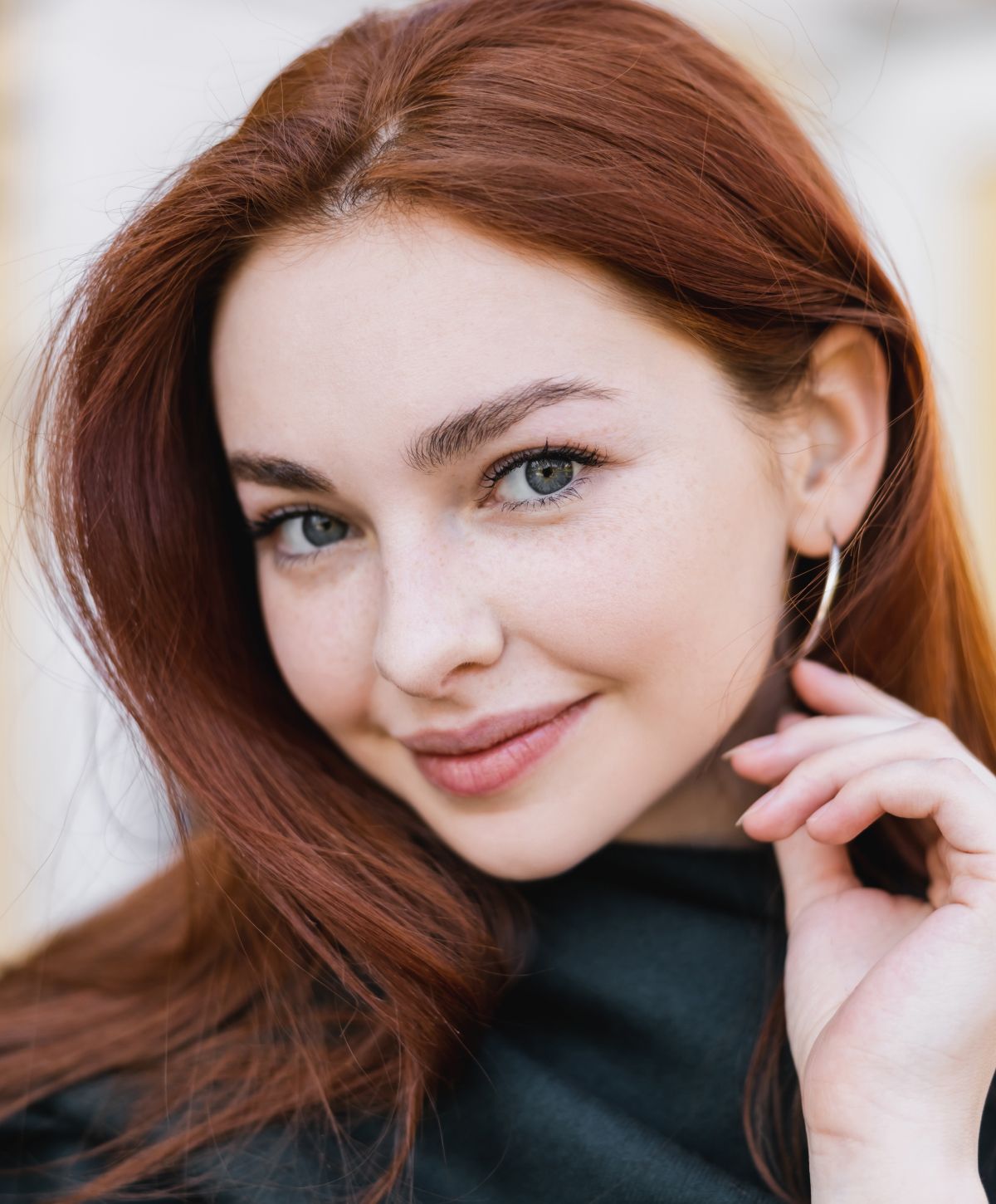 Model posing elegantly in a stylish outfit.