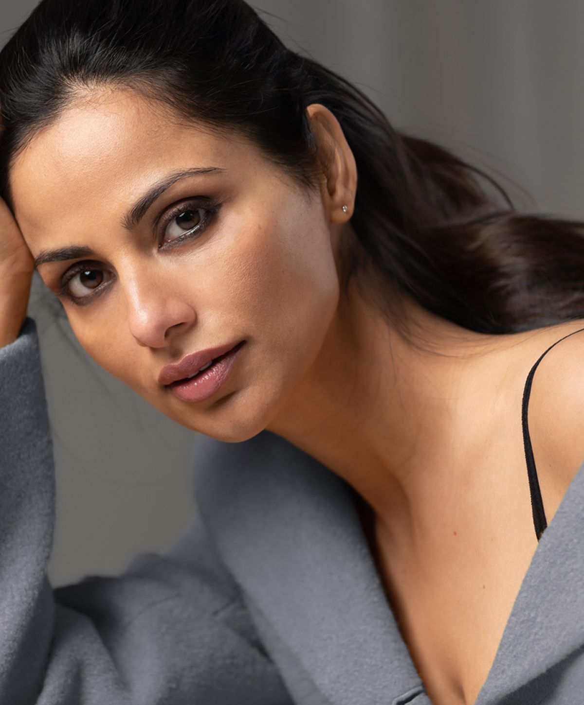 Close-up of woman with natural makeup and expression.