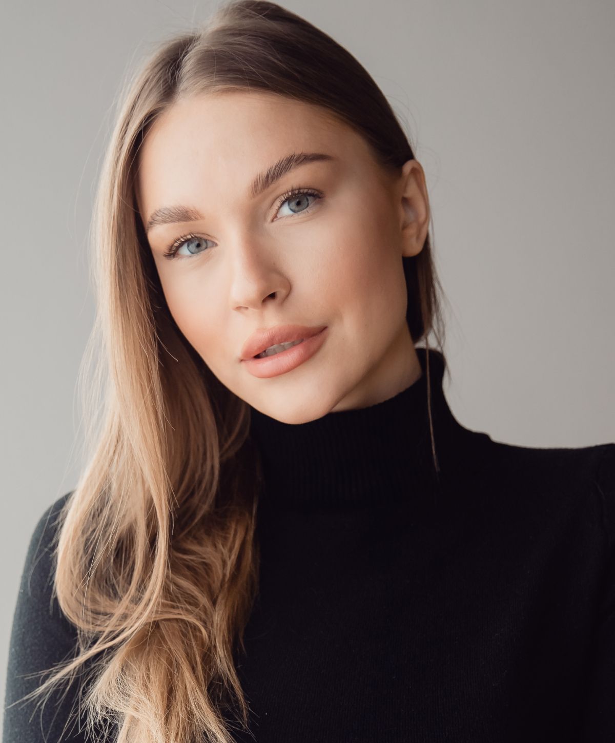 Portrait of a woman with long blonde hair.