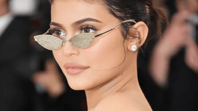 Woman in stylish sunglasses at an event.