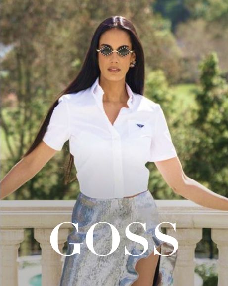 Stylish woman posing outdoors in trendy fashion.