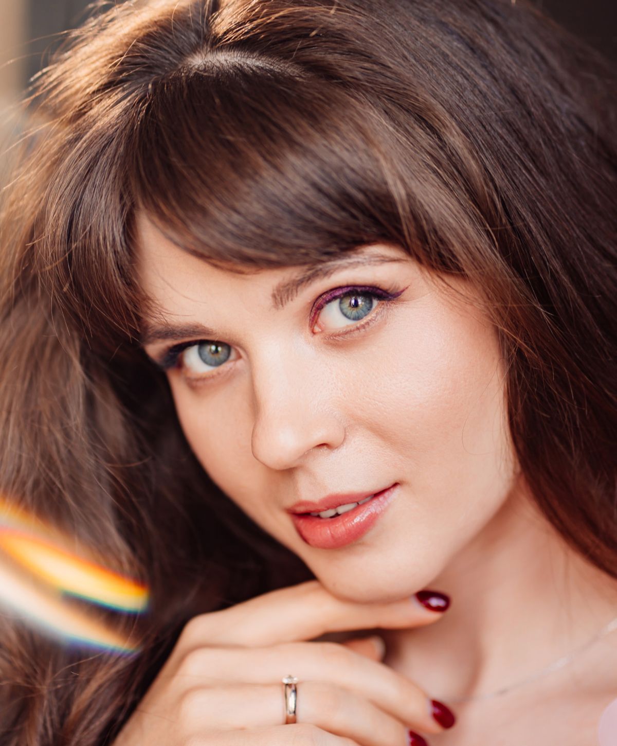 Young woman with long hair and green eyes.