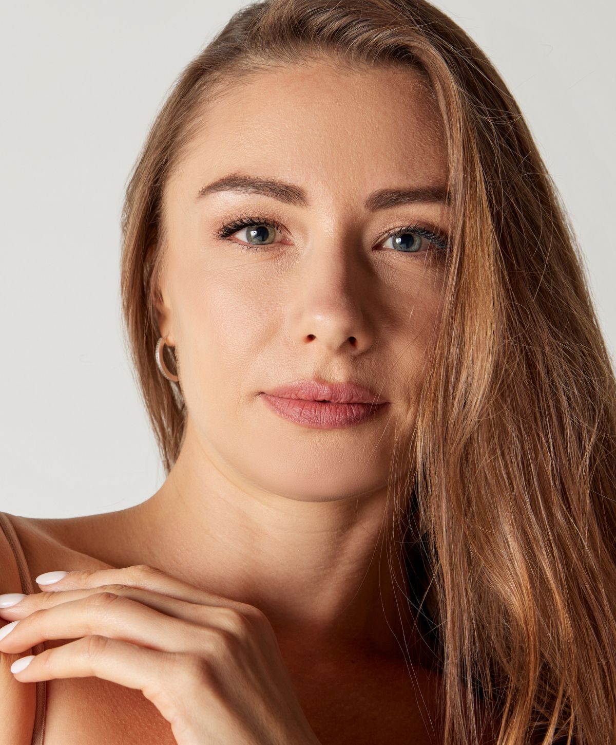 Woman with long hair and natural makeup.
