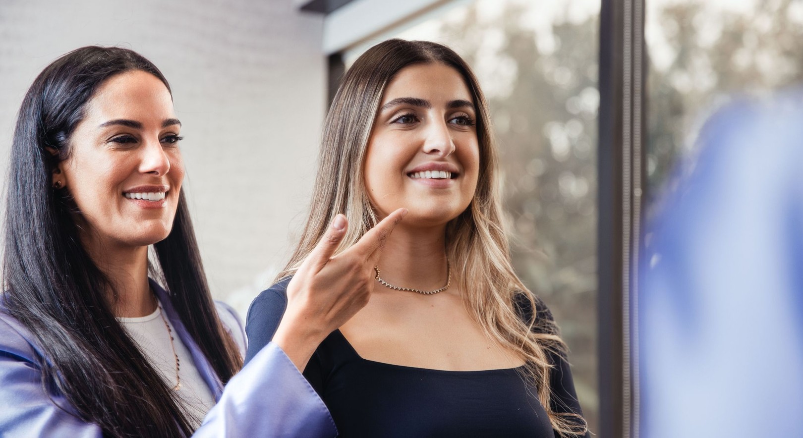 Two women comparing her face tightening results