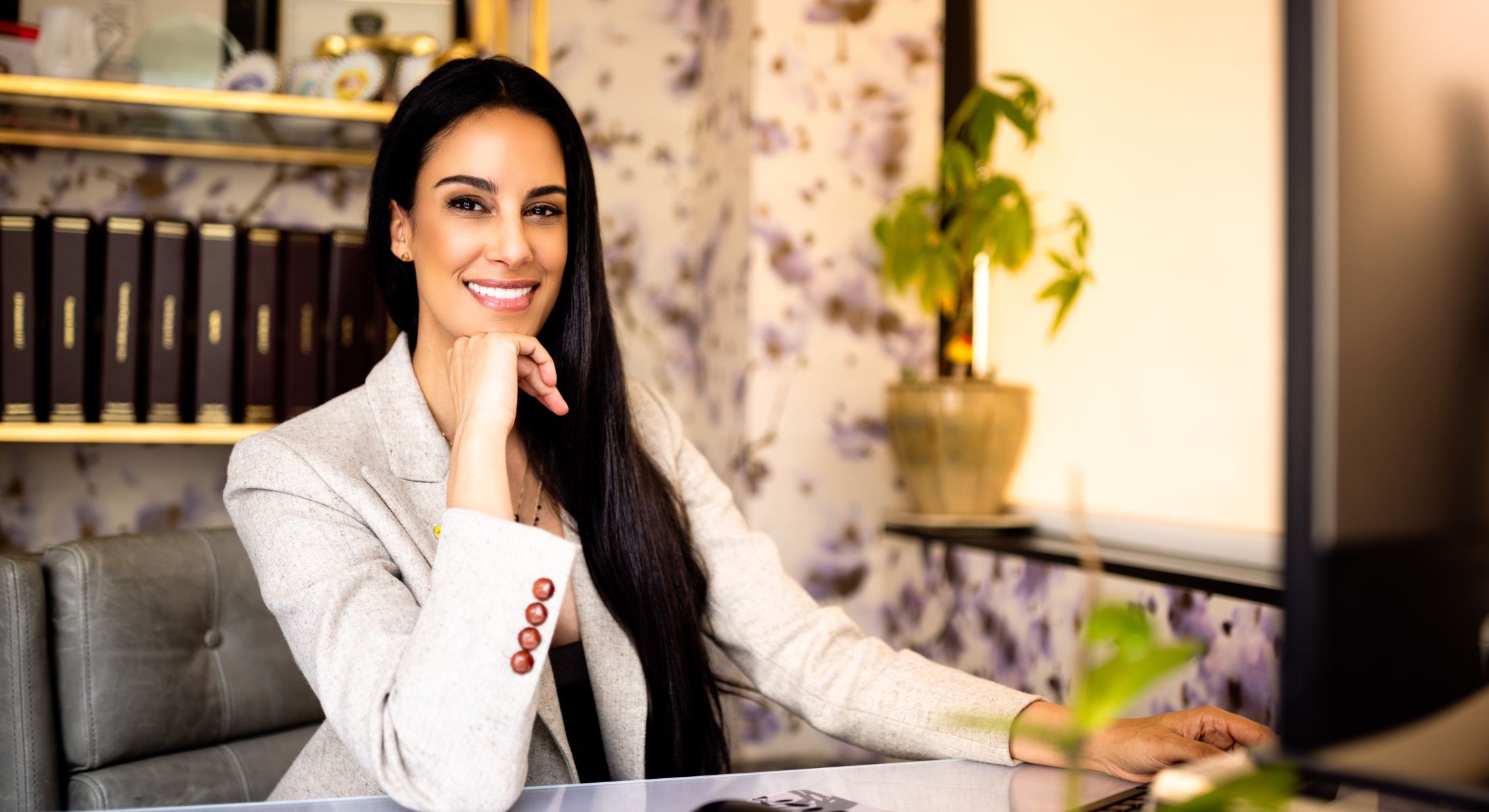 Smiling professional woman in an office setting.