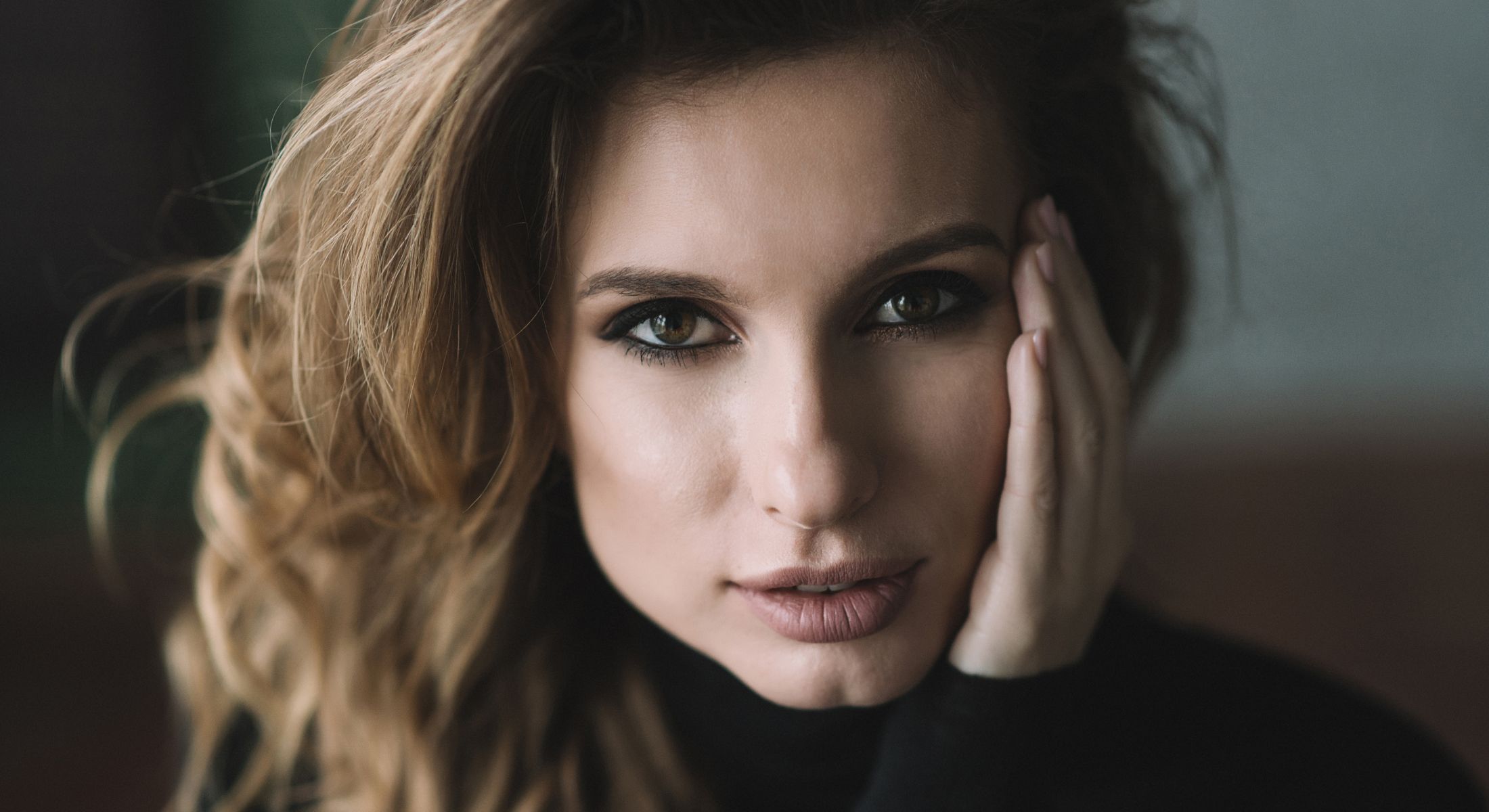 Close-up of woman with thoughtful expression.