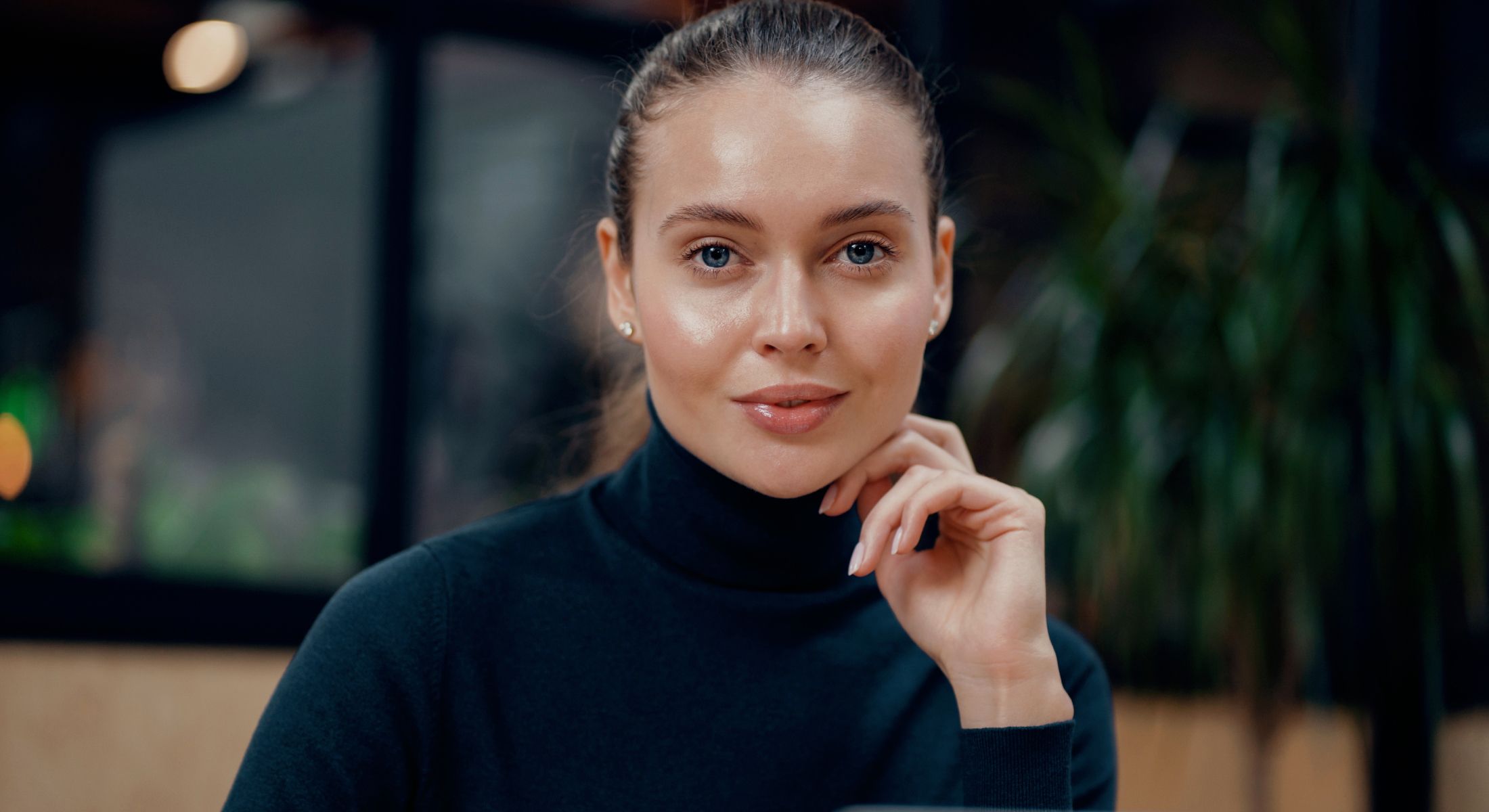 Portrait of a woman in a turtleneck sweater.