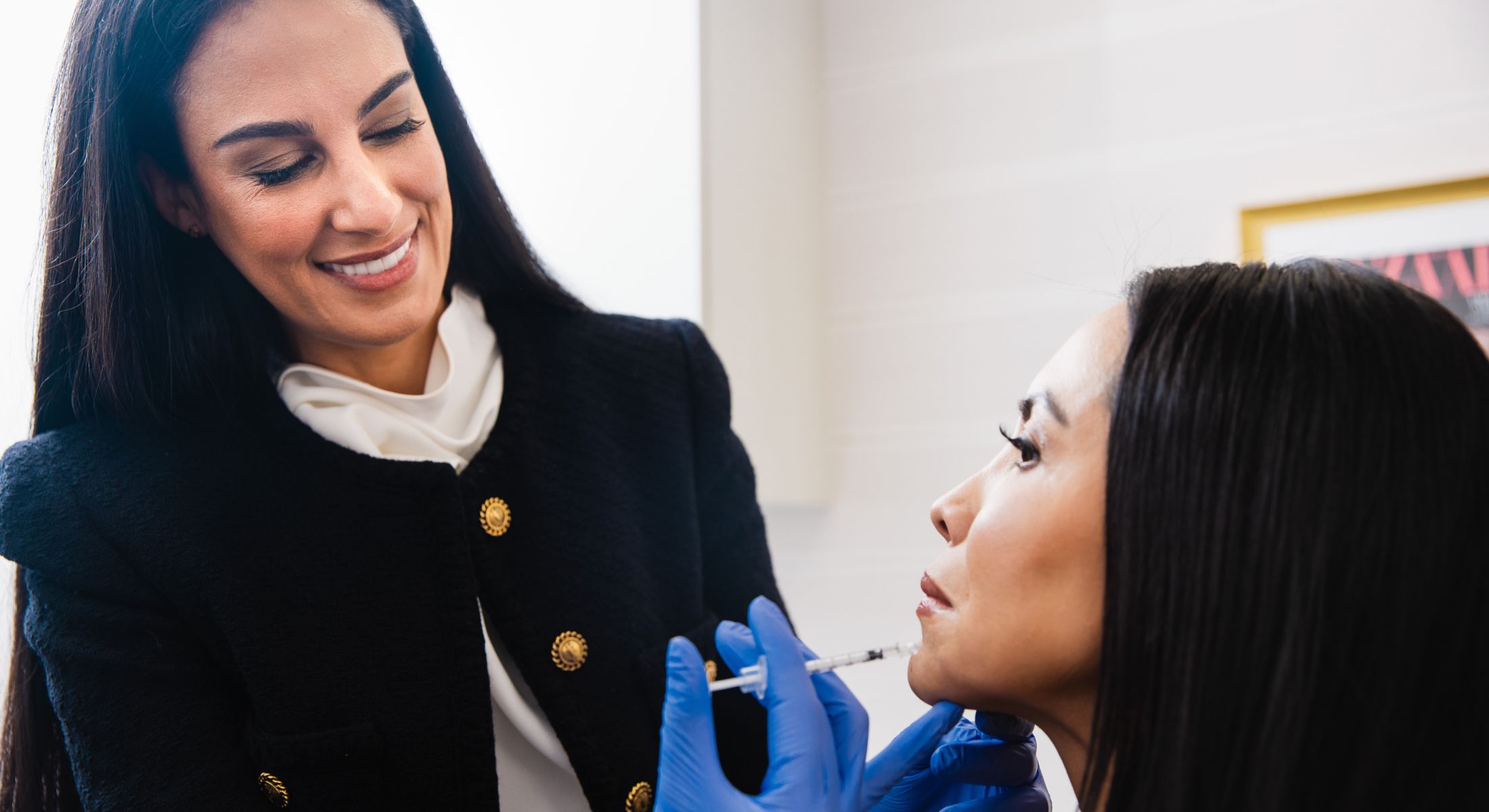 Cosmetic treatment consultation between two women.