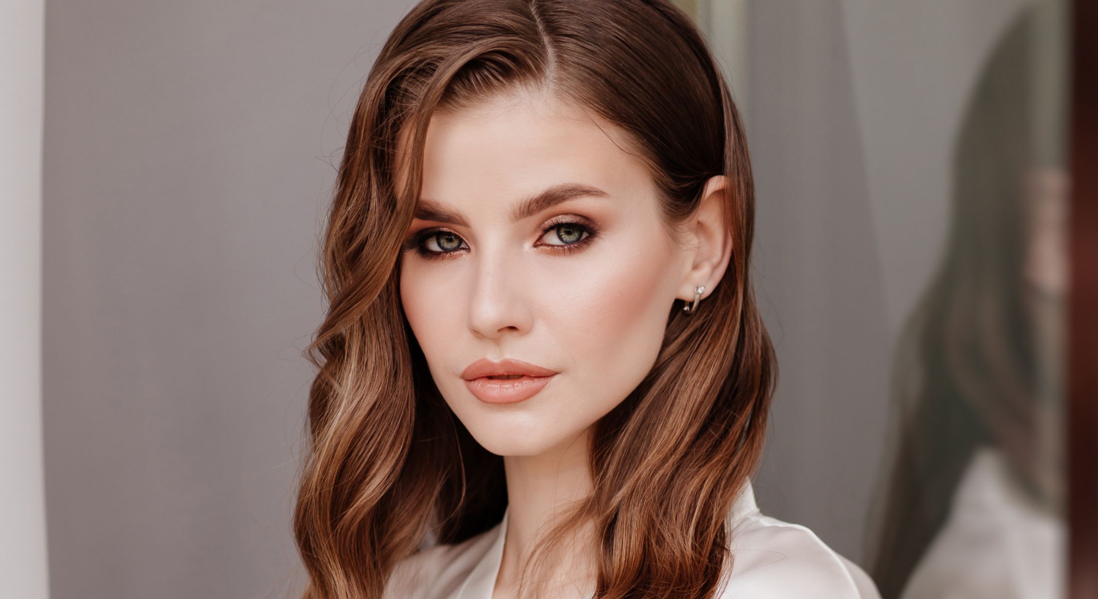 Portrait of a woman with wavy brown hair.